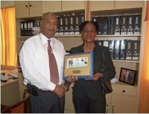 Minister in the Finance Ministry, Juan Edghill receives his plaque from Attorney Richards