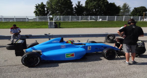 Calvin Ming watches on as his mechanics run some last-minute tests on his F4 Car which will be in Guyana at the CMRC 2015 final leg. 