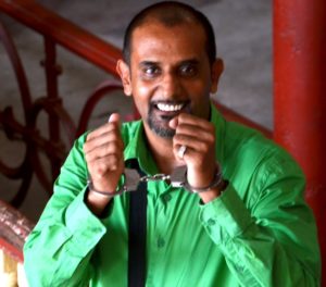 Police escorting Beekham out of the Georgetown Magistrates’ court on Thursday