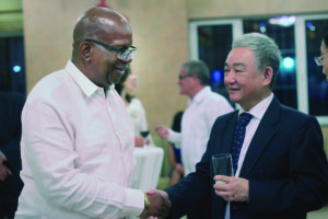 Finance Minister Winston Jordan shares a light moment with Ambassador  Zhang Limin during celebrations held on Friday last at the Embassy
