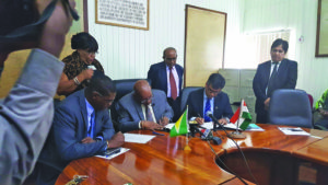 Finance Minister Winston Jordon and India-Import (EXIM) Bank resident representative Sailesh Prasad sign the 20-year agreement